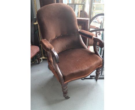 A 19th century mahogany showframe open armchair, button upholstered in a chocolate Dralon, on turned and castored supports