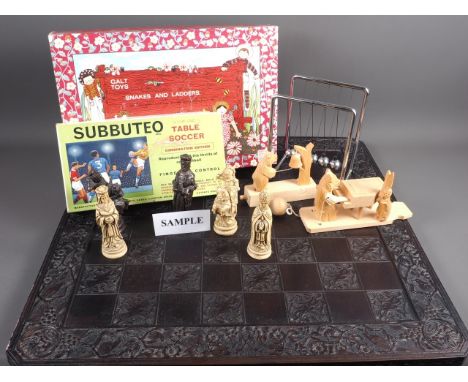A quantity of toys and games, including Russian carved hardwood toys, a chess board with pieces, a set of Newtons balls, Subb