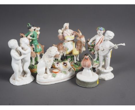 A pair of Staffordshire model figures, mounted on goats, 5 1/4” high (repairs), a similar model of a poodle and a cat, a Derb