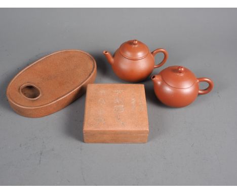 A Chinese terracotta square-shaped box and cover with character decoration and seal mark to base, 3 1/4” square, two Yixing p