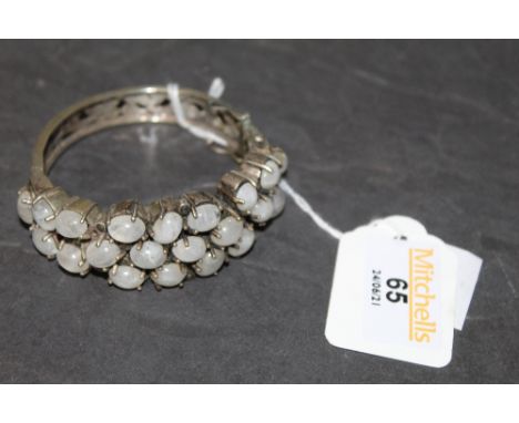 A cast white metal and moonstone bangle