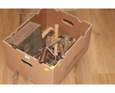 A box of miscellaneous tools to include levels, rules etc  