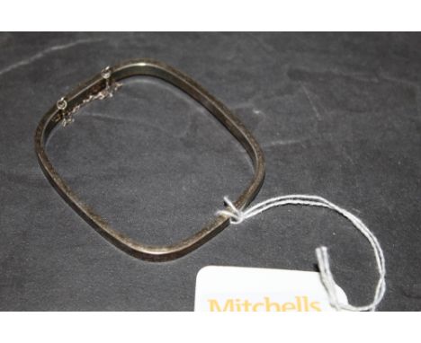 A 925 grade white metal bangle with rounded square form, 11 grams