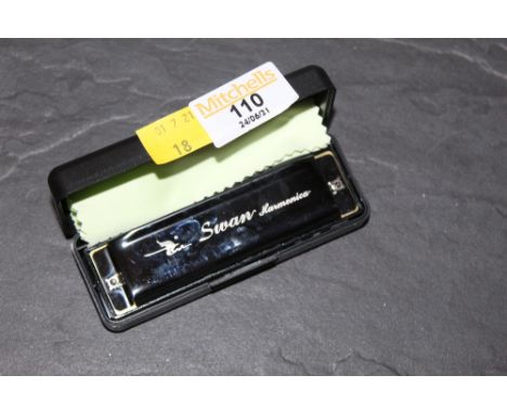 A swan harmonica (cased)