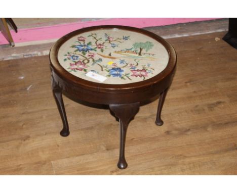 A 1920's mahogany circular coffee table, the top inset with needlework tapestry depicting gondolier, pagoda and flowers, on c