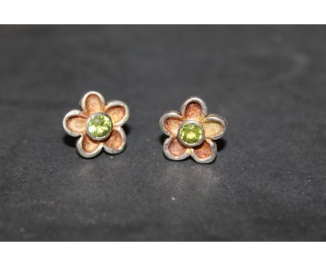 A pair of 925 silver and enamel flower head earrings with central green stone (thought to be peridot)