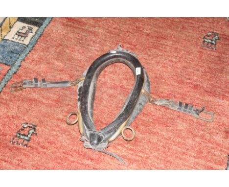 A vintage black leather and brass horse collar of small proportions 