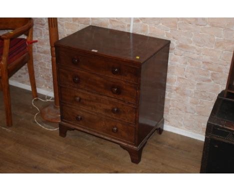 A George IV figured mahogany commode chest, with lifting top and four dummy drawer fronts on bracket feet, 72 cm high, 65 cm 