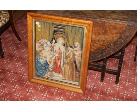 A Victorian polychrome wool work embroidery/tapestry depicting a religious scene with figures, within a gilt slip and maple f