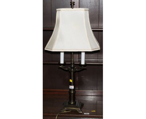 A decorative brushed brass effect table lamp with shade