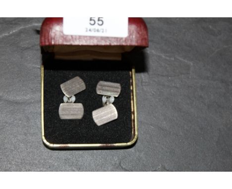 A pair of engine turned white metal cufflinks, each marked "silver"