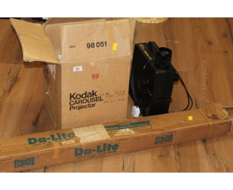 A Kodak carousel projector and da-lite projector screen 