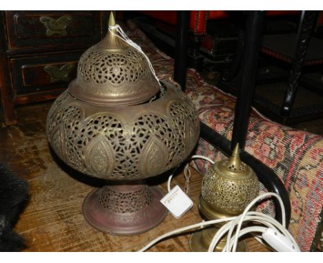 A Moroccan pierced copper ceiling pendant, together with similar table lamp. 
