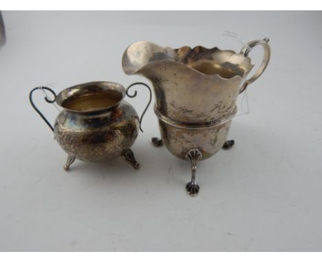 An Edwardian silver helmet-shaped cream jug, in the George II style, hallmarked Chester 1908, together with a mid 20th centur