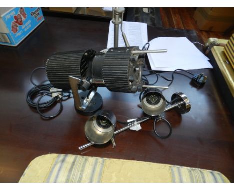 A black and chrome spotlight lamp, together with one other spotlight.