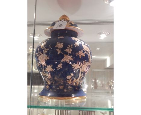 A Spode porcelain baluster shaped urn, decorated with cranes and foliage, bears factory mark to base. H: 30cm