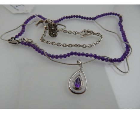 An amethyst bead necklace, together with an amethyst and silver pendant on chain, a pair of silver and amethyst earrings, and