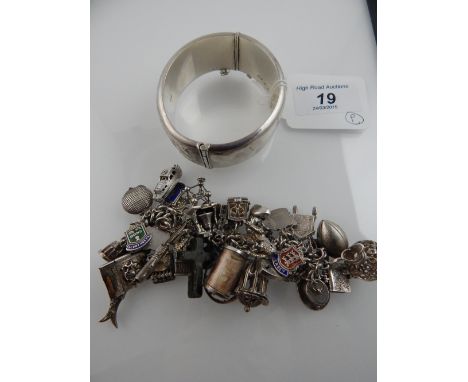 A silver charm bracelet, hung various charms including a piano, the Copenhagen mermaid, a Punch and Judy theatre, speedboat, 