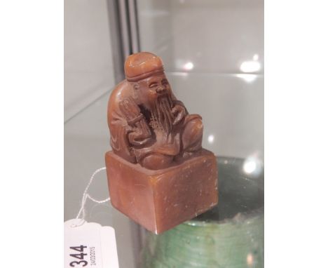 A Chinese soapstone seal, moulded with Buddha to top,  H.8cm