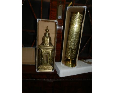 An Indian style brass wall lamp, having tiered decoration, together with a brass ceiling light.