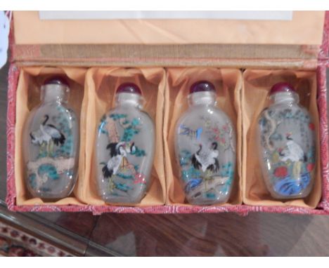 A cased set of four Chinese glass scent bottles, together with a parquetry cribbage board, and a Treen serving bowl. 