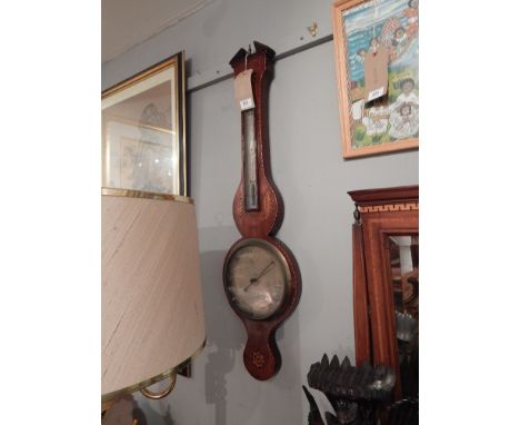 A late George III mahogany wheel barometer, decorated with shell marquetry paterae, the silvered dial signed 'J. Silver', and