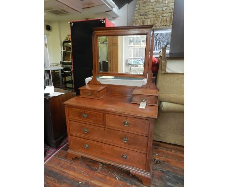 An Edwardian mahogany and satinwood cross-banded dressing chest, fitted a bevel plate mirror above an arrangement of six draw
