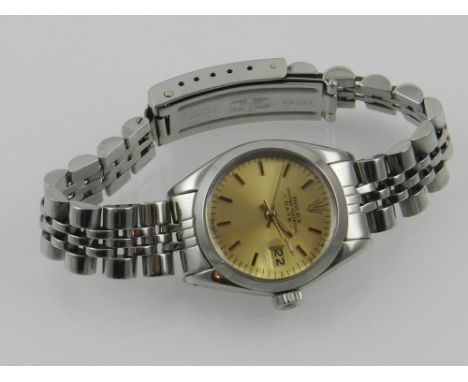 Rolex Geneva. A ladies stainless steel wristwatch, having a tonno case, with champagne baton dial, with bubble date aperture 
