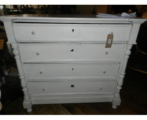 A late 19th century French white painted commode, fitted four long drawers flanked by turned column supports, floral feet. H.