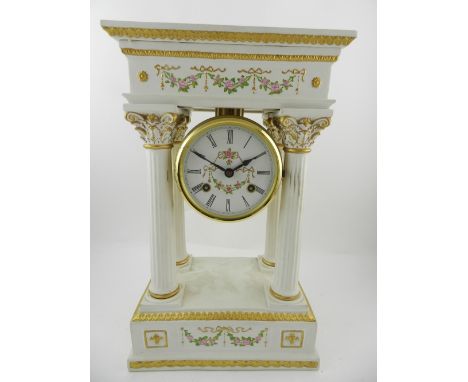 A Franklin mint bisque porcelain portico clock, in the Louis XVI style, parcel gilded and painted with roses, set eight-day c