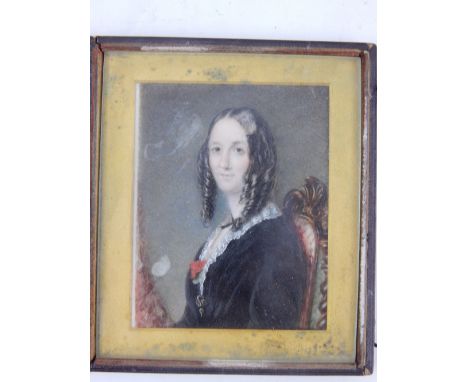 A mid 19th century British School, a half length seated portrait on ivory panel, study of a lady in mourning dress. 