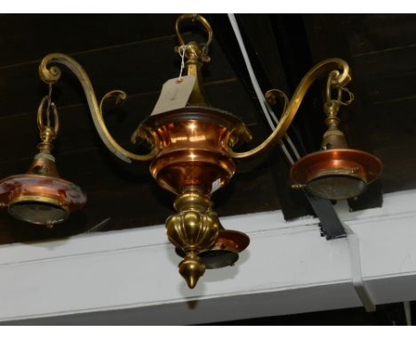 An early 20th century three branch three light brass chandelier.