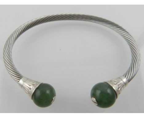 A white metal and jade open bangle. 