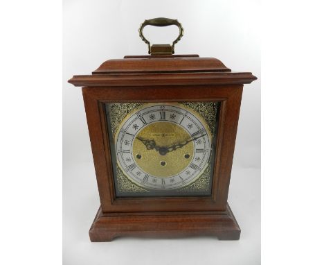 A 17th century style American stained beechwood bracket clock, by Howard Miller, having an eight-day movement, chiming gongs.