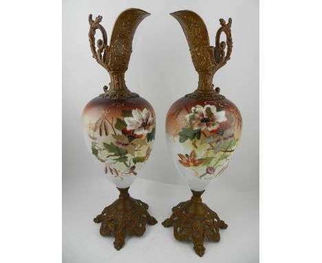 A pair of Worcester style ormolu mounted ornamental ewers, painted with flowers and foliage, H.45cm  