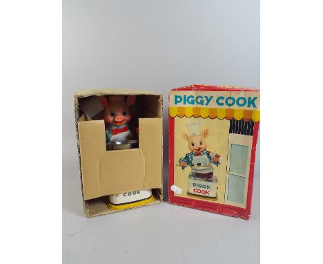 A Vintage Battery Operated Automaton Toy, Piggy Cook. 
