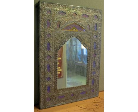 WALL MIRROR, 19th century Indo Persian, embossed metal framed, with gilt and blue painted reserves of script to the surround,
