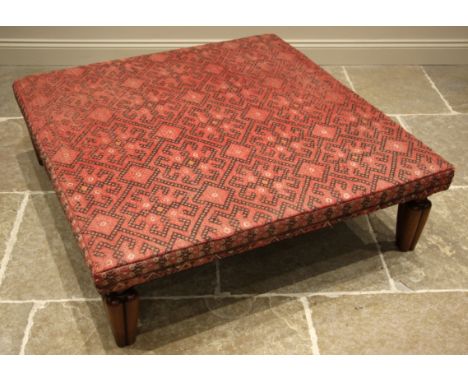 A kilim foot stool, of country house proportions, the square top covered in red and black geometric fabric, upon mahogany leg
