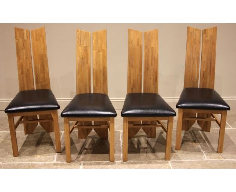 A set of four contemporary light oak and leather dining chairs, each with a full length 'split' board back rest, padded leath