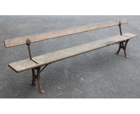 A late 19th/early 20th century railway platform bench by Addison &amp; Co, Wellington, the swing-over back rest upon cast iro