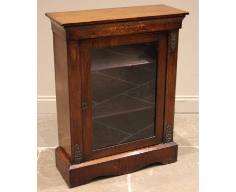 A Victorian figured walnut pier cabinet, the cavetto moulded frieze inlaid with a boxwood foliate motif, over the single glaz