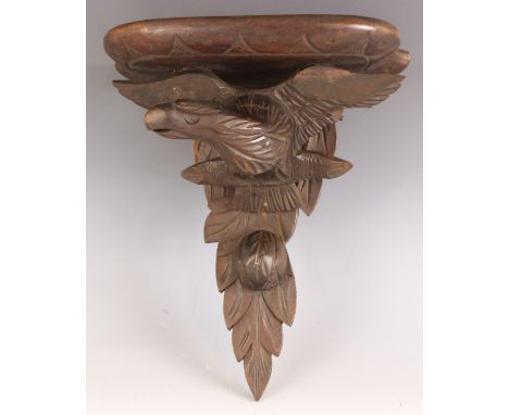 A Black Forest type wall bracket, early 20th century, modelled as an eagle, outstretched wings upon a back plate carved in re