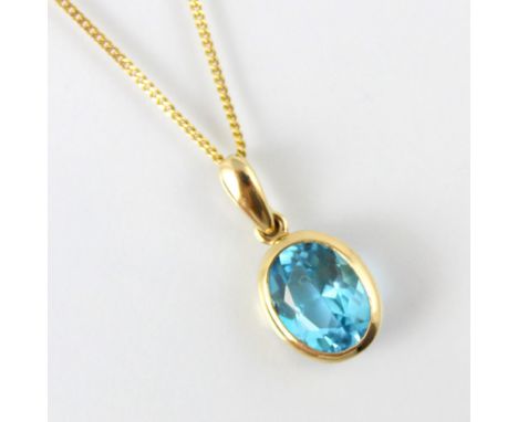An untested blue topaz pendant, the oval cut blue stone within 9ct yellow gold rub over mount, stamped to reverse, upon an as