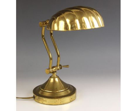 An Art Deco lacquered brass desk lamp, early 20th century, the shade modelled as a half shell, 17cm W x 18.5cm D, the stepped