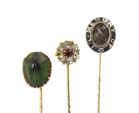 A 19th century enamel mourning stick pin, the oval head with 'in memory of' lettering within an enamel border, a glazed apert