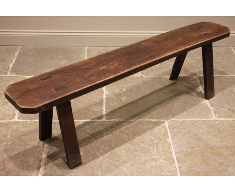 A rustic ash bench, 19th century, the slab top with canted corners, upon tapering and splayed supports, 46cm H x 168cm W x 28