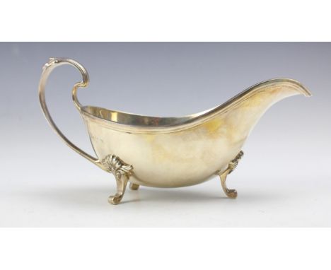 A late 20th century silver sauce boat, Garrard &amp; Co Ltd, Sheffield 1978, the florally capped handle above grooved rim and