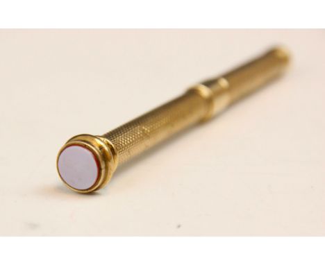 A 20th century gold plated propelling pencil, with engine turned detail and banded hardstone terminal, 9.5cm long, 13gms with