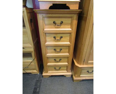 A light oak chest of five drawers, 122cm high