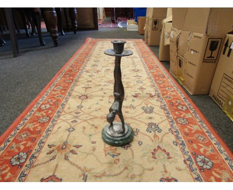 An Art Deco Pewter nude woman candlestick in a handstand position on a green marble base